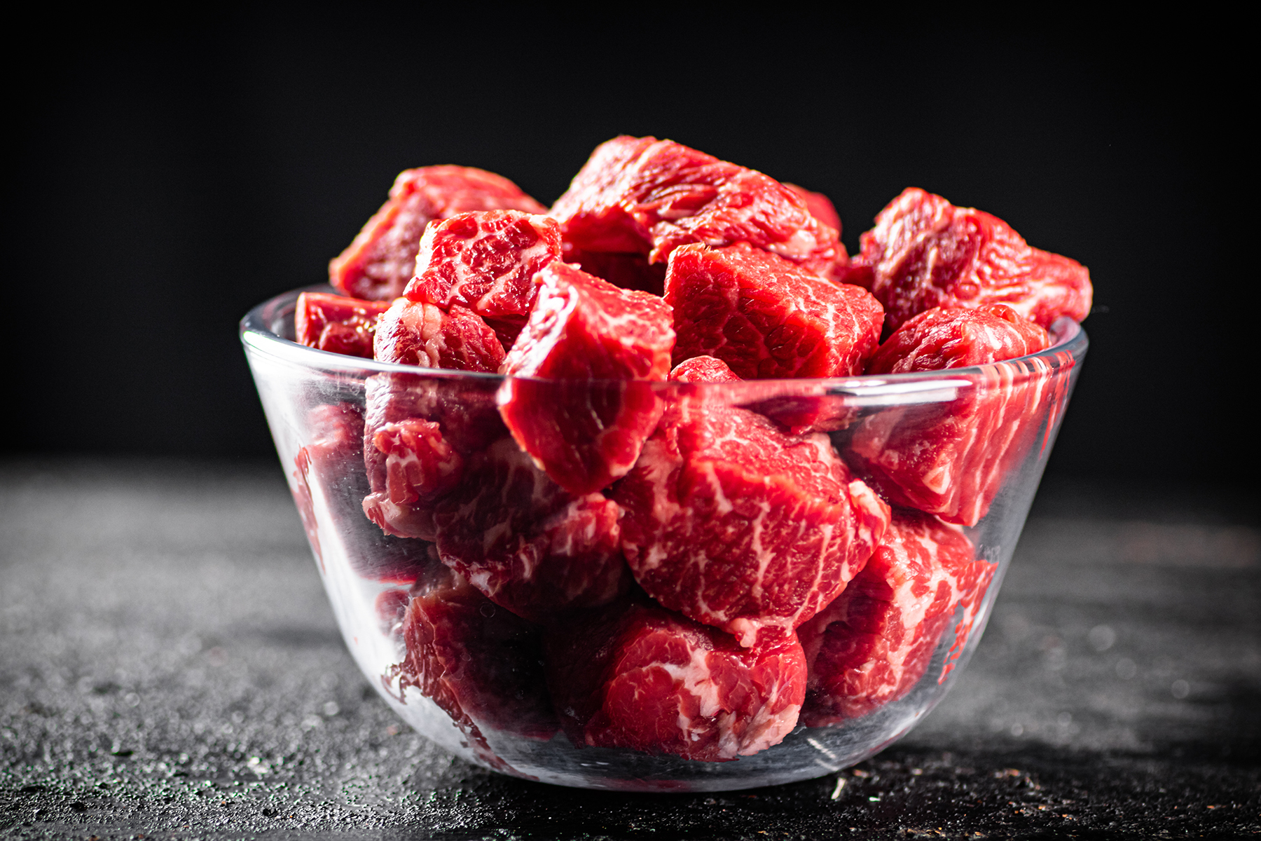 raw pieces of beef in a glass bowl